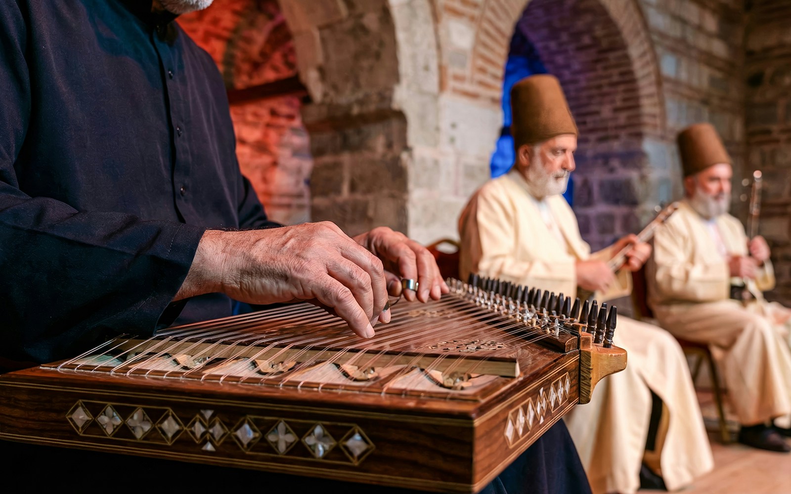 Whirling Dervishes performing in a historic venue with an audience in Istanbul.