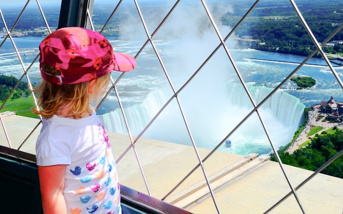 Child viewing Niagara Falls from observation deck, Canada and USA tour.