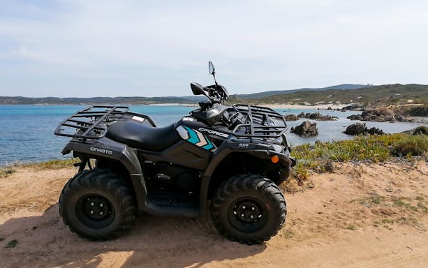 Quad bike on coastal trail in Santa Teresa di Gallura, Sardinia.