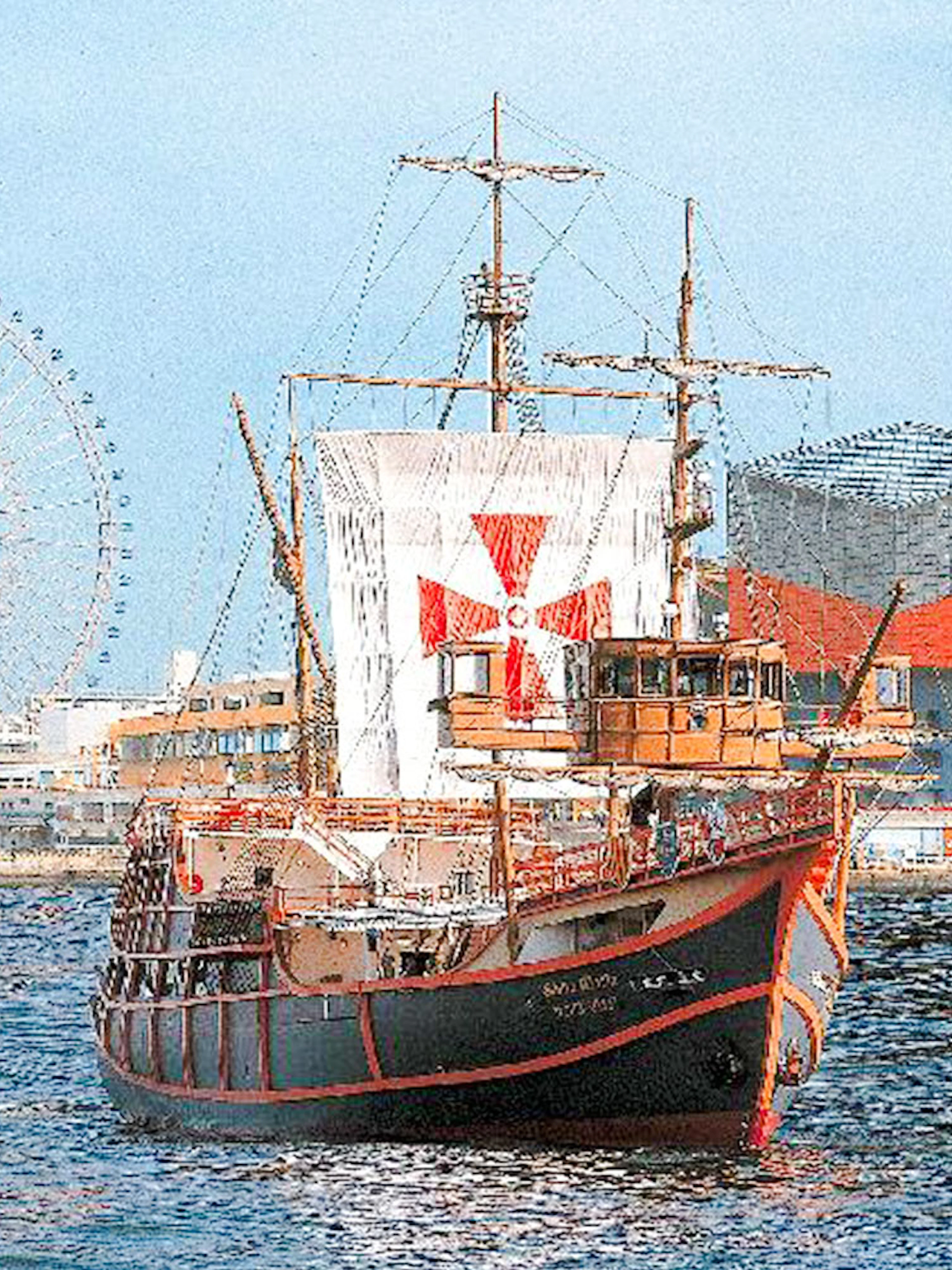 Santa Maria cruise ship in Osaka Bay with Tempozan Ferris Wheel and Osaka Aquarium Kaiyukan.