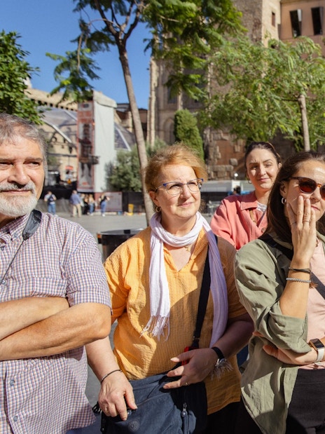 Tourists listening to a guide during a walking tour in Barcelona.