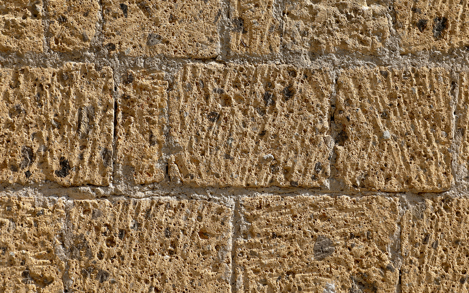 Volcanic tuff stone walls in underground Spanish quarters.