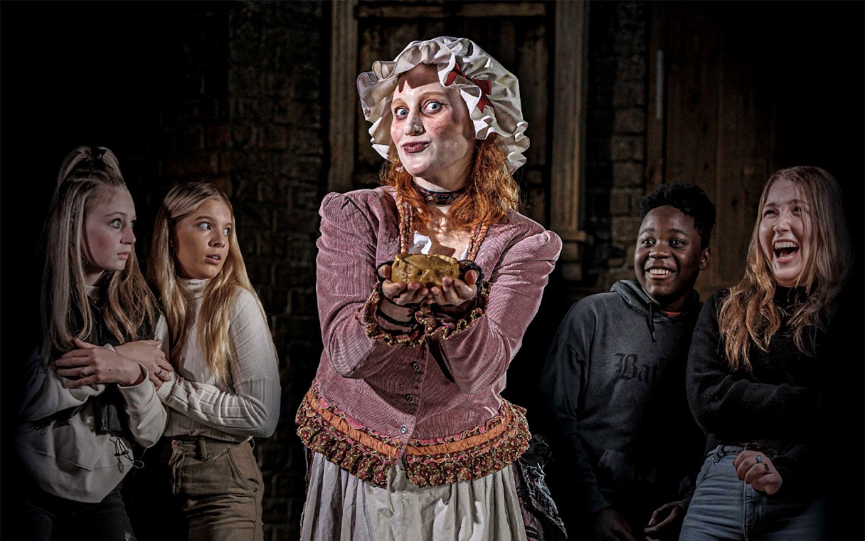 Mrs Lovett presenting a pie to amused visitors at London Dungeon.