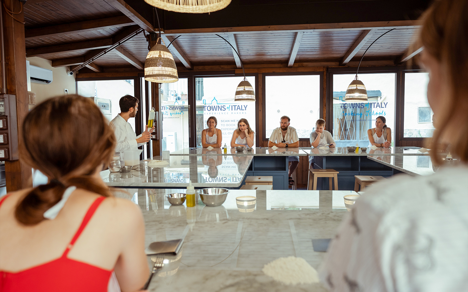 Cooking class participants in Palermo learning to make pizza and gelato.