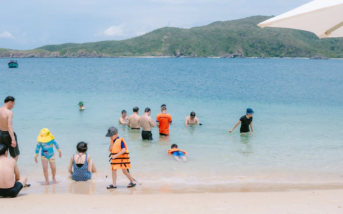 People enjoying the beach and swimming at Green Oasis Beach, Nha Trang.
