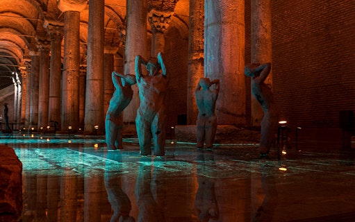Basilica Cistern interior with illuminated columns and statues during guided walking tour in Istanbul.