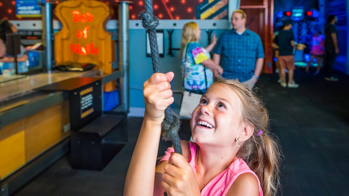 Child enjoying rope challenge at Physical Challenge Zone, Wonderworks Orlando.
