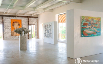 Art gallery interior with paintings and sculpture at Driftwood Village, Hoi An.