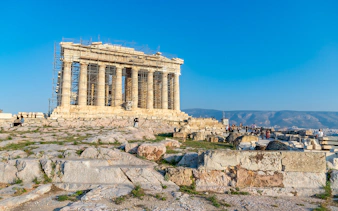 Acropolis with scaffolding and tourists during a guided bike tour in Athens, Greece.