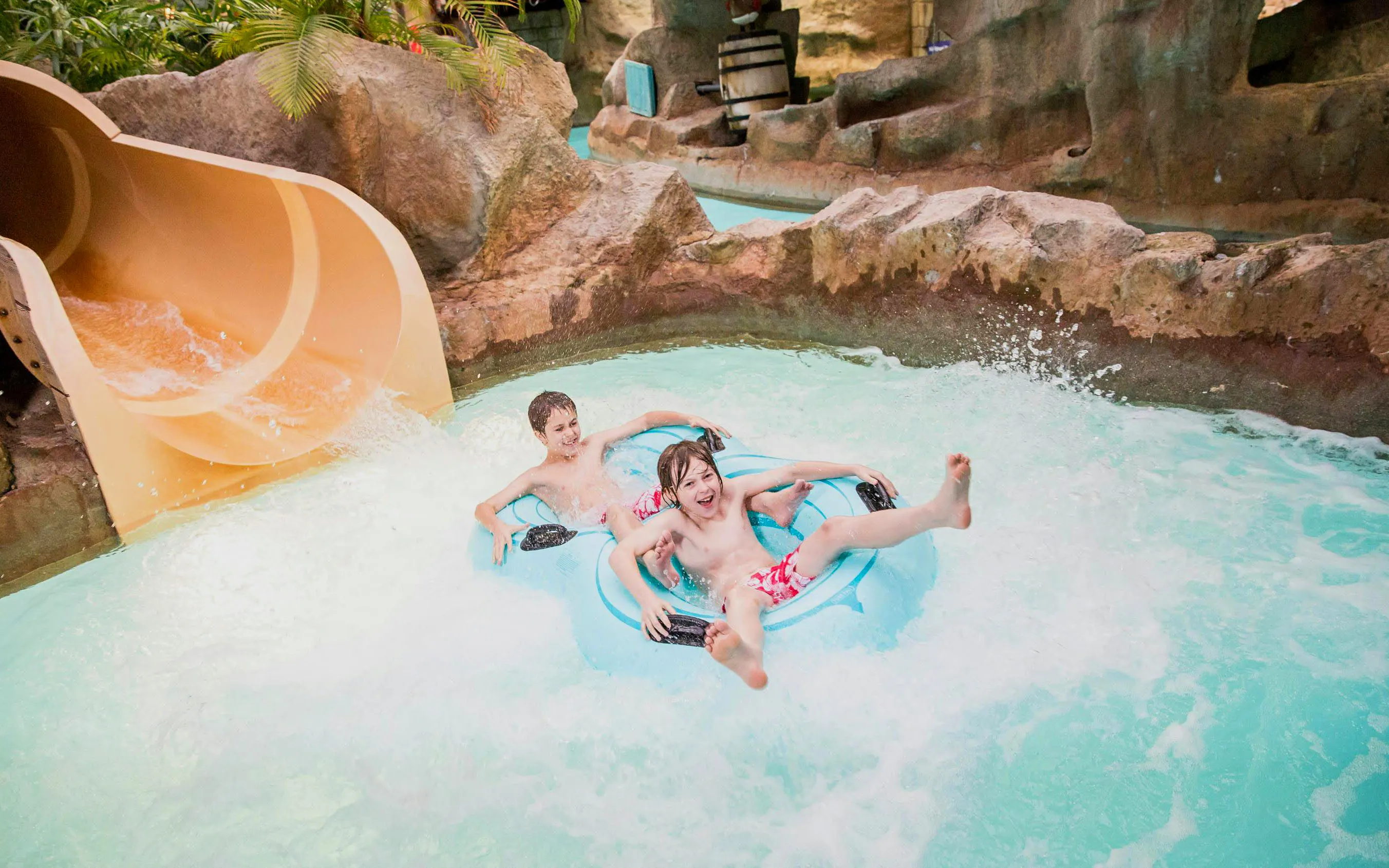 Children enjoying a water slide at Alton Towers Waterpark.