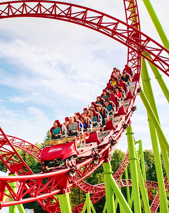 Roller coaster with riders on a red and green track at Six Flags Over Georgia.
