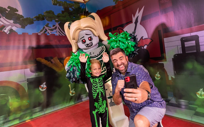 Guest taking selfie with Lego zombie at Brick or Treat, Legoland Florida.