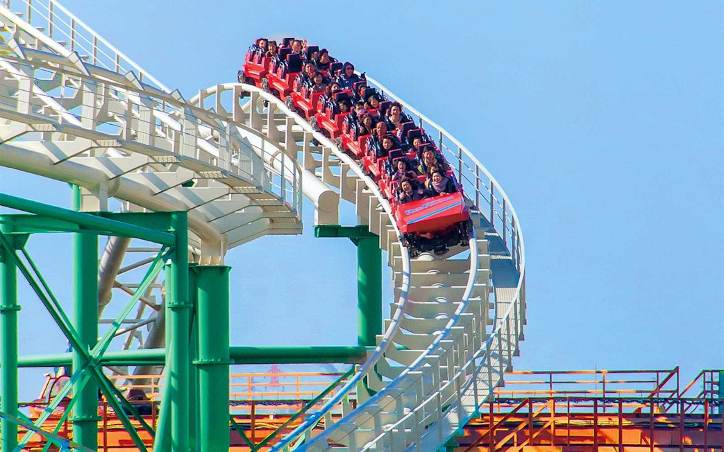 Roller coaster ride at Hirakata Park, Japan, with passengers on a steep track.