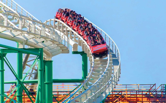 Roller coaster ride at Hirakata Park, Japan, with passengers on a steep track.