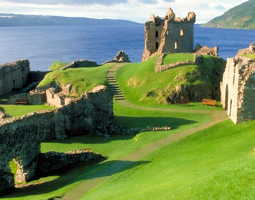 Urquhart Castle ruins overlooking Loch Ness on a sunny day, part of Inverness day tour.