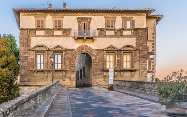 Entrance to Museum of San Pietro in Colle Val d'Elsa, Italy, with historic architecture.