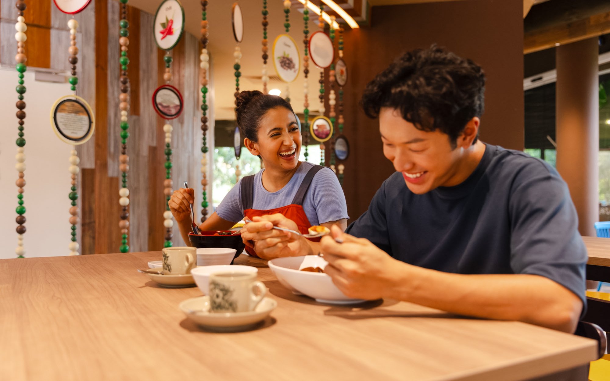 Dining experience at Sentinel Foodhall, Rainforest Wild Adventure, with two people enjoying a meal.
