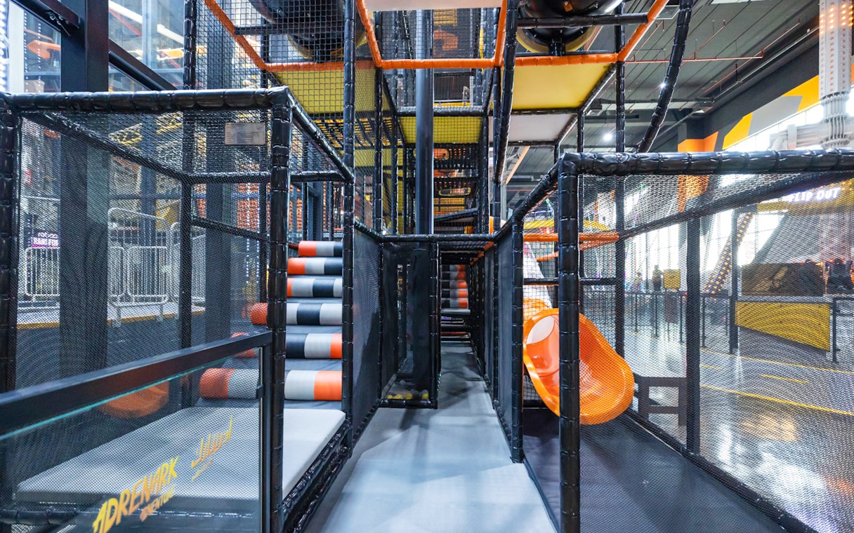 Indoor adventure playground with slides and climbing structures at Adrenark Adventure.