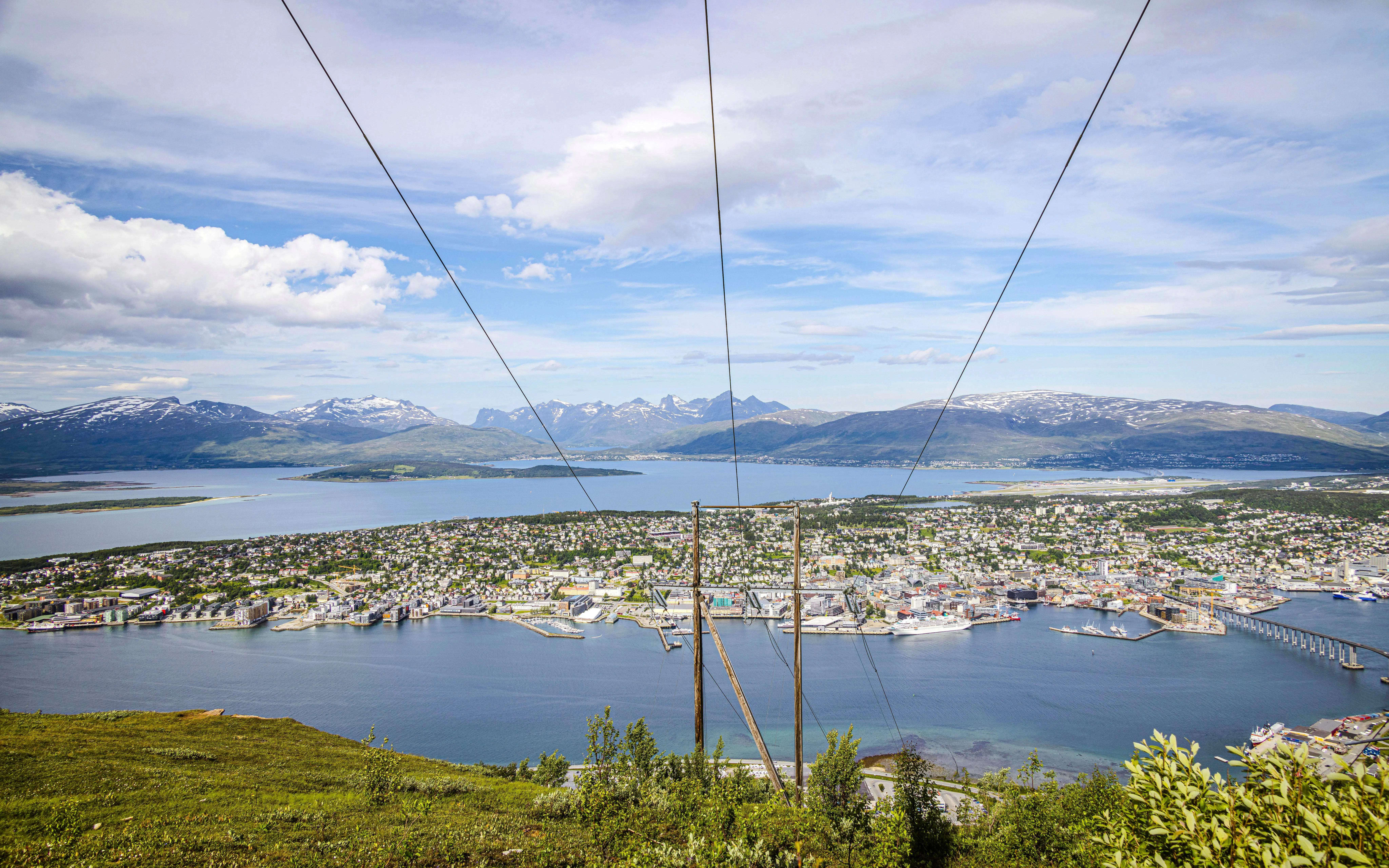 Tromso cityscape and fjord view from Storsteinen mountain ledge, Norway.