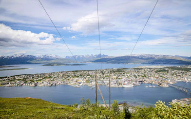 Tromso cityscape and fjord view from Storsteinen mountain ledge, Norway.