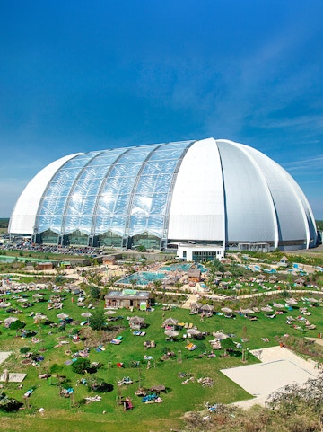 Tropical Islands Resort dome with outdoor pool and sunbathing area near Berlin.