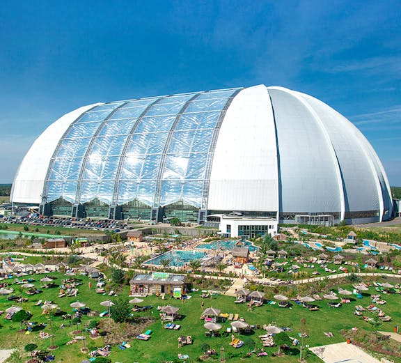 Tropical Islands Resort dome with outdoor pool and sunbathing area near Berlin.