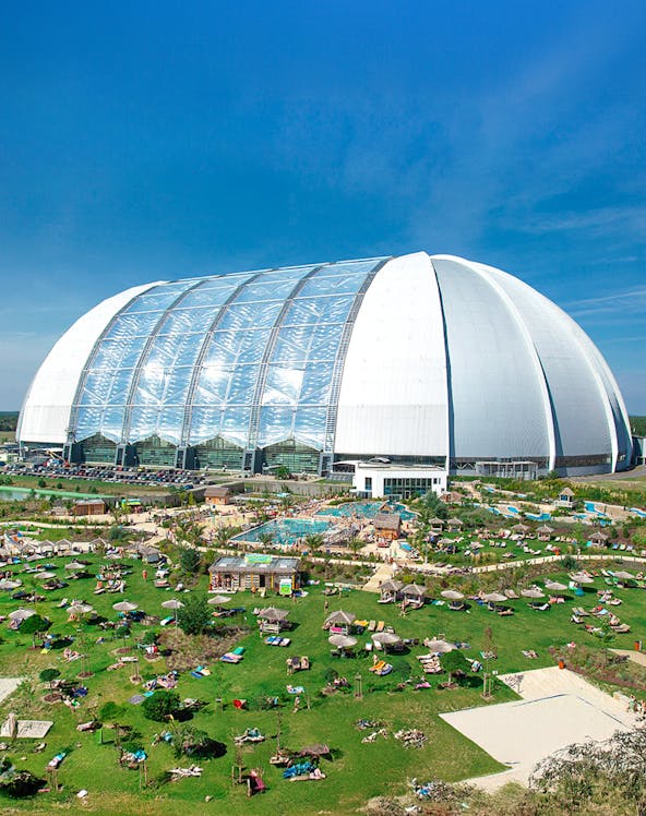 Tropical Islands Resort dome with outdoor pool and sunbathing area near Berlin.