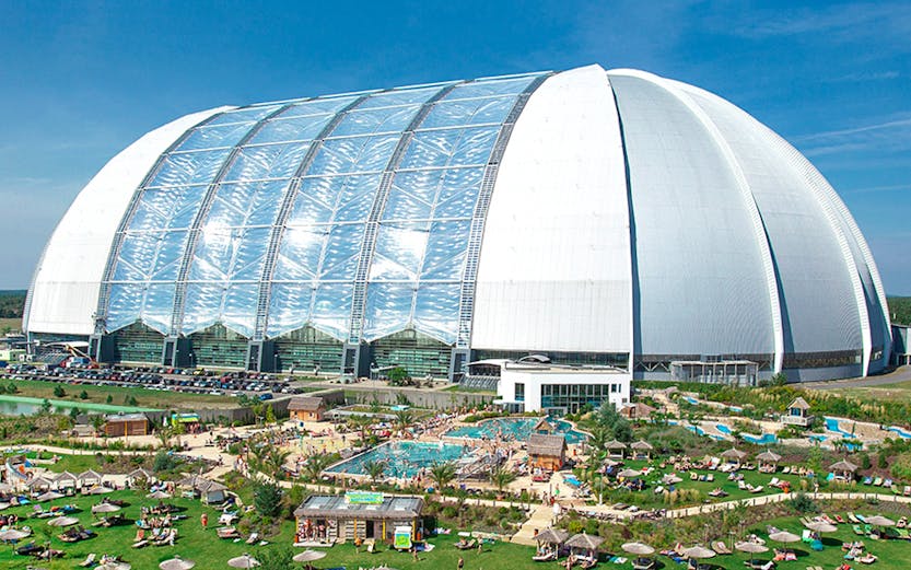 Tropical Islands Resort dome with outdoor pool and sunbathing area near Berlin.