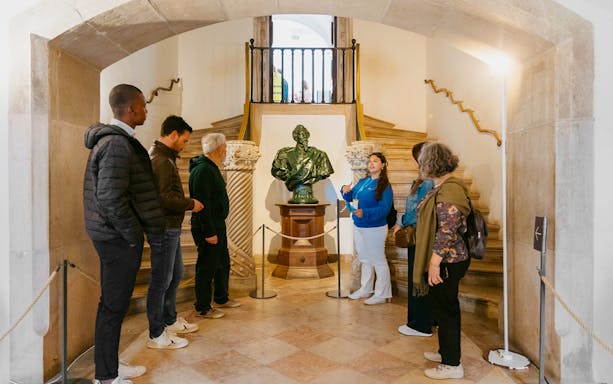Pena Palace in Sintra with tourists exploring the vibrant architecture on a guided tour.