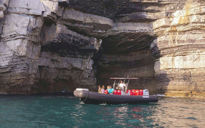 Boat tour near rocky cliffs in Portovenere, La Spezia, Italy.