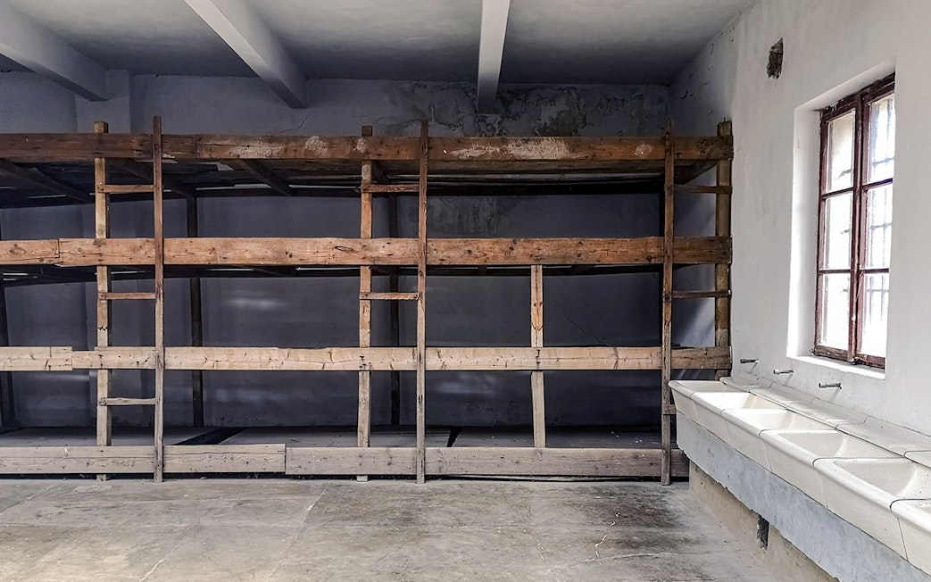 Bunk beds and sinks inside a cell at Terezin concentration camp.