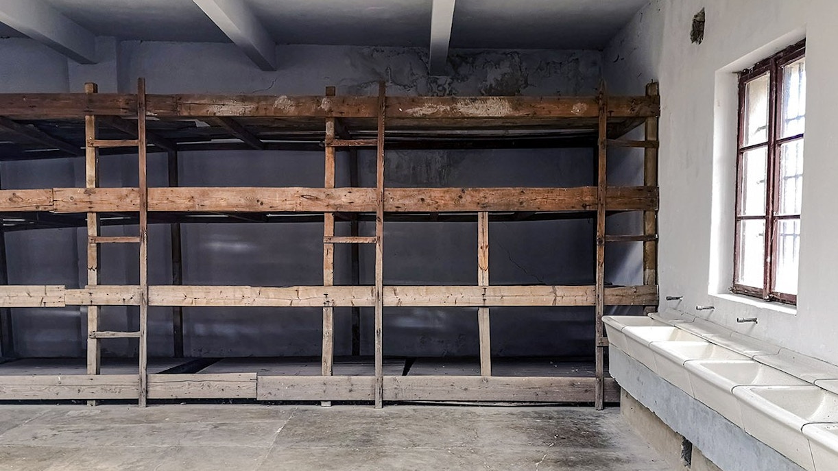 Bunk beds and sinks inside a cell at Terezin concentration camp.