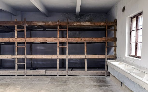 Bunk beds and sinks inside a cell at Terezin concentration camp.