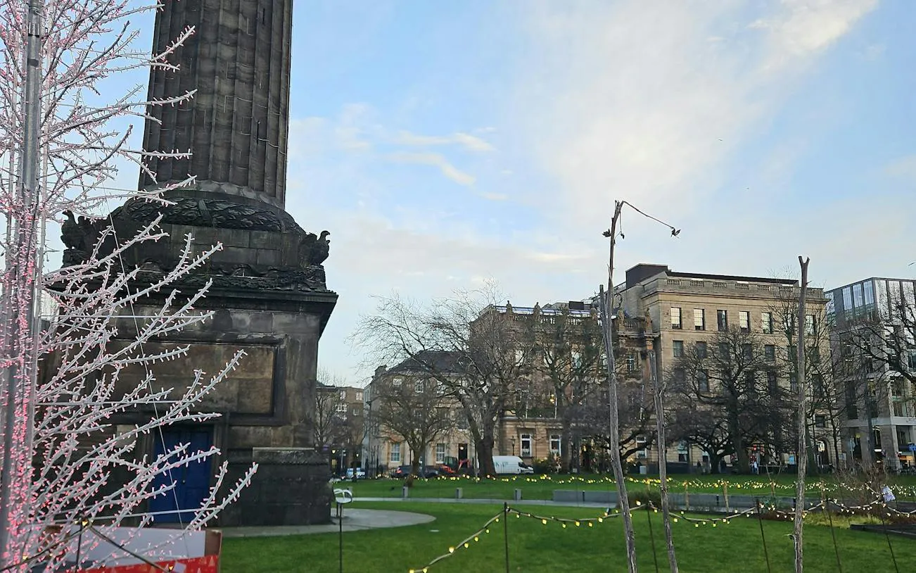 Monument and historic buildings in Edinburgh city park, part of self-guided detective mystery tour.