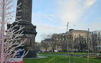 Monument and historic buildings in Edinburgh city park, part of self-guided detective mystery tour.