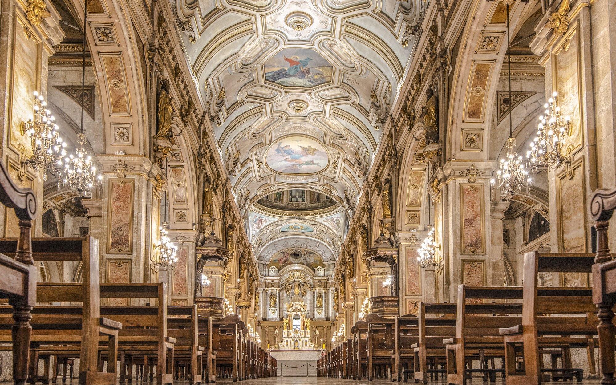 Santiago Cathedral interior with ornate ceiling and chandeliers.