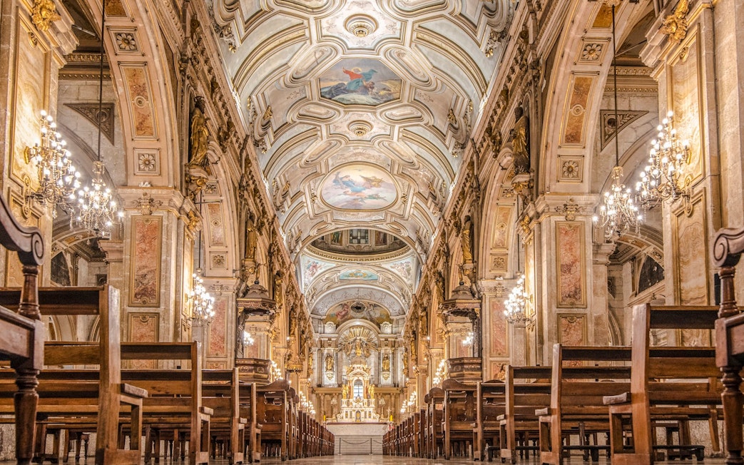 Santiago Cathedral interior with ornate ceiling and chandeliers.
