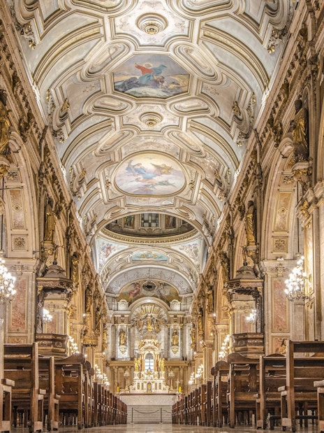Santiago Cathedral interior with ornate ceiling and chandeliers.