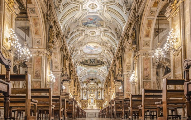 Santiago Cathedral interior with ornate ceiling and chandeliers.