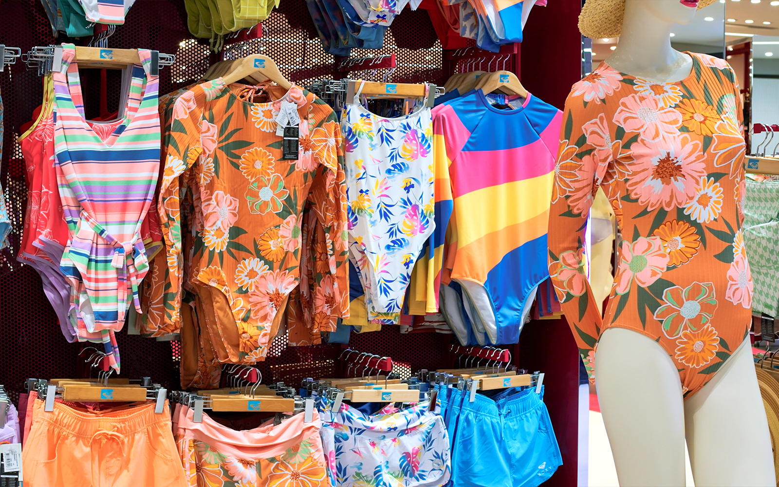 Swimwear shop display with colorful bikinis and swimsuits in Barcelona, Spain.
