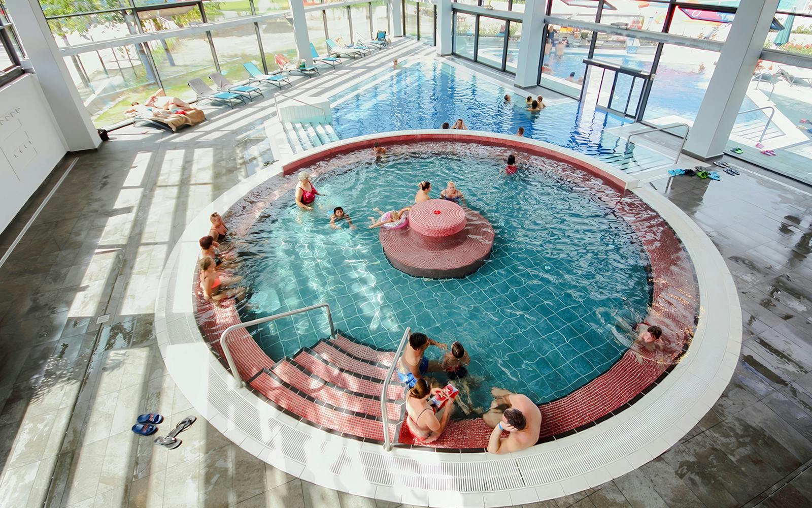 Indoor pool with people relaxing at Paskal Thermal Bath, Budapest.