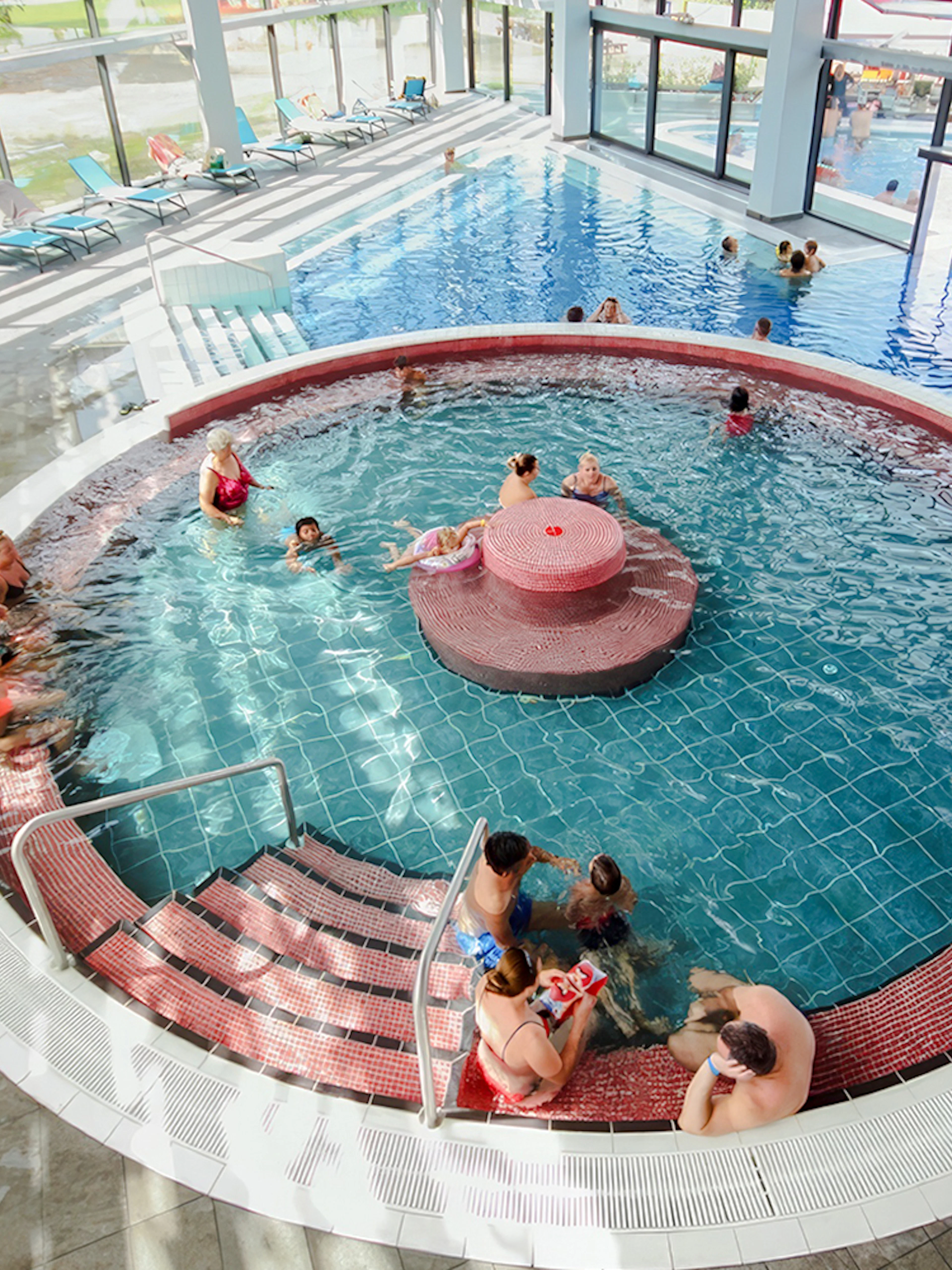 Indoor pool with people relaxing at Paskal Thermal Bath, Budapest.