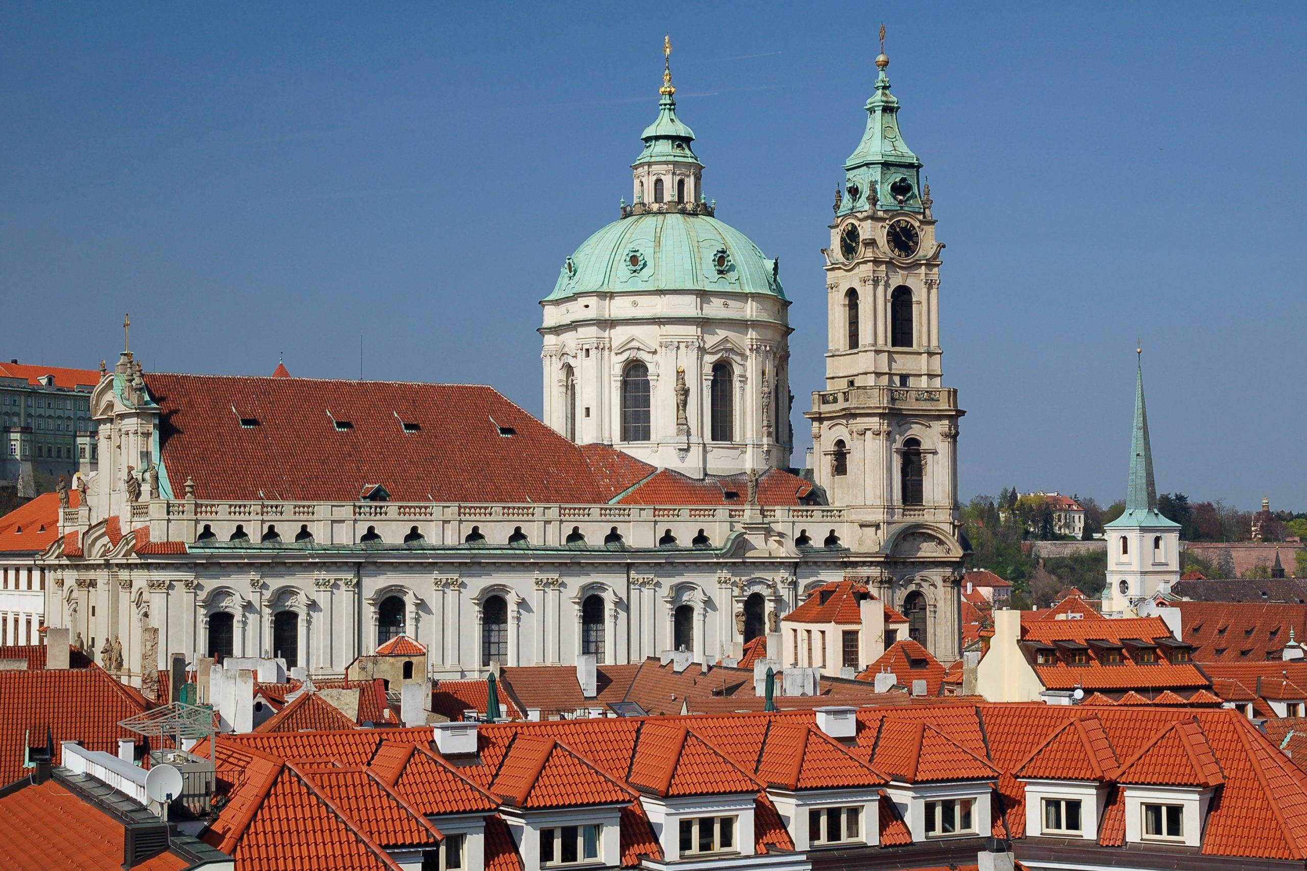 St. Nicholas Bell Tower and church in Prague with red rooftops.
