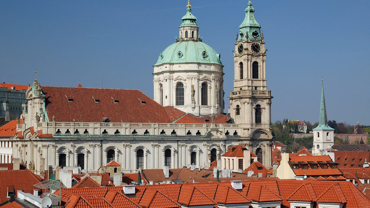 St. Nicholas Bell Tower and church in Prague with red rooftops.
