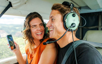 Couple enjoying scenic views on a Kauai air tour.