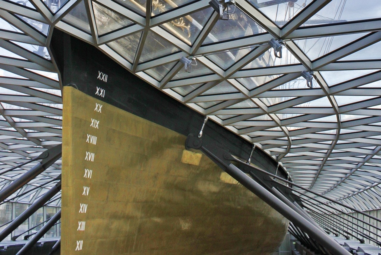 Cutty Sark hull under glass canopy in Greenwich, London.
