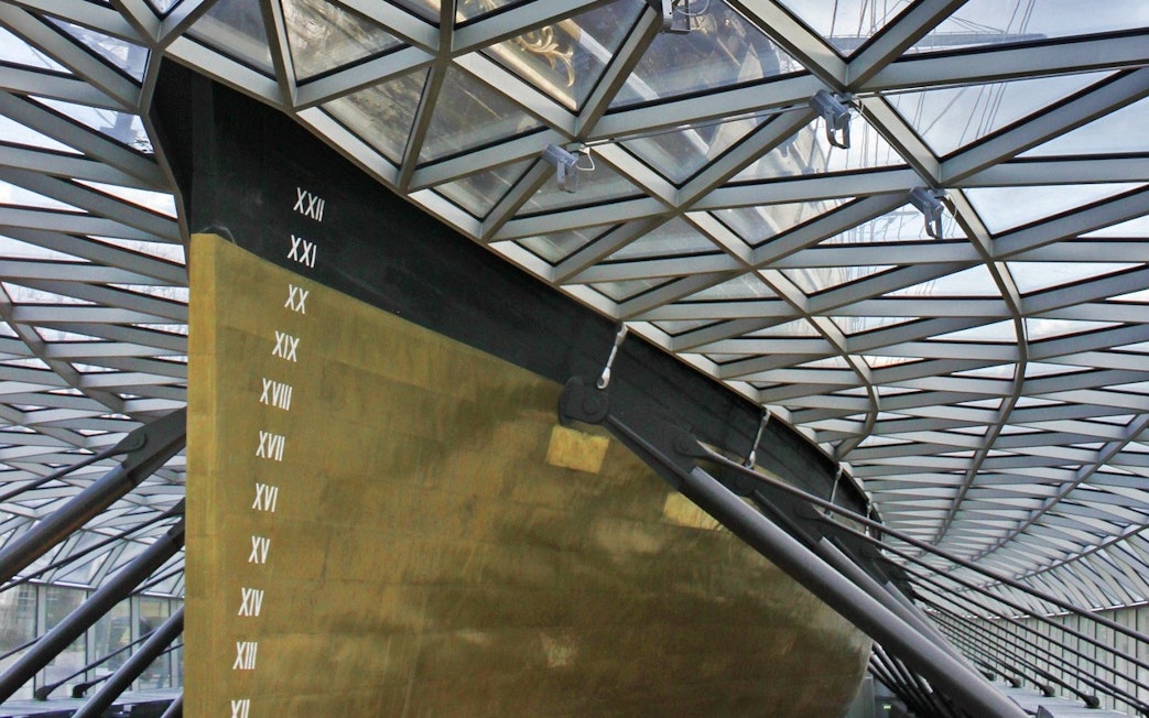 Cutty Sark hull under glass canopy in Greenwich, London.
