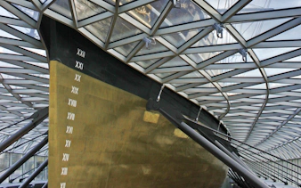 Cutty Sark hull under glass canopy in Greenwich, London.