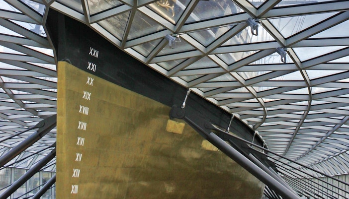 Cutty Sark hull view in Greenwich, London, showcasing historic ship's design.