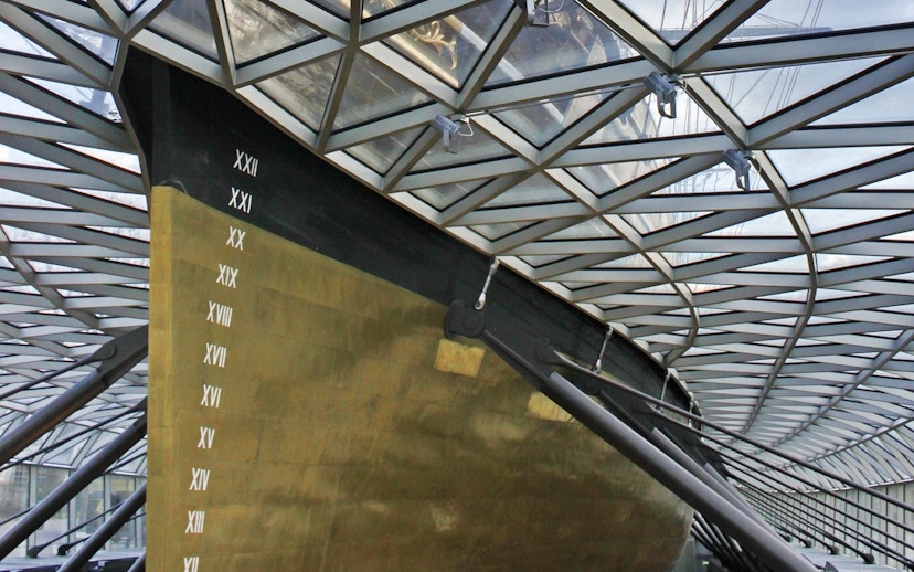 Cutty Sark hull under glass canopy in Greenwich, London.